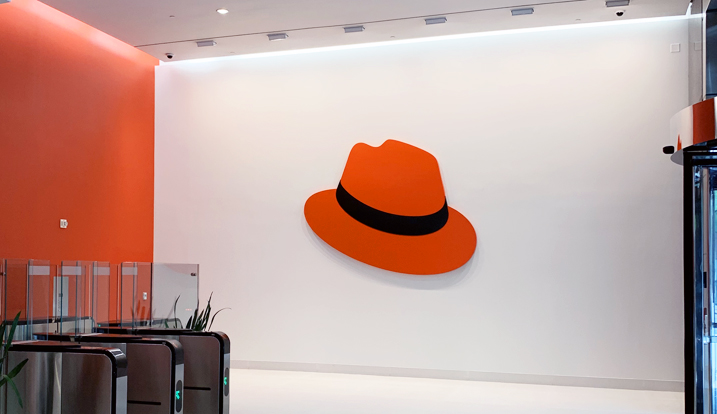 Photograph of the Red Hat Tower lobby featuring a large hat on the wall.