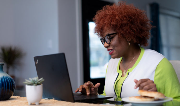 A professional woman working on a laptop