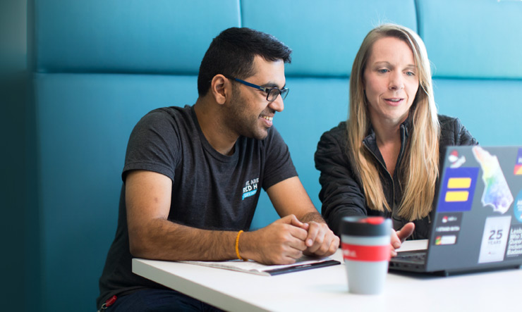 Red Hat co-workers in a booth