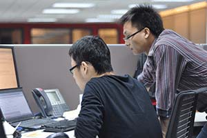 Two men looking at computer