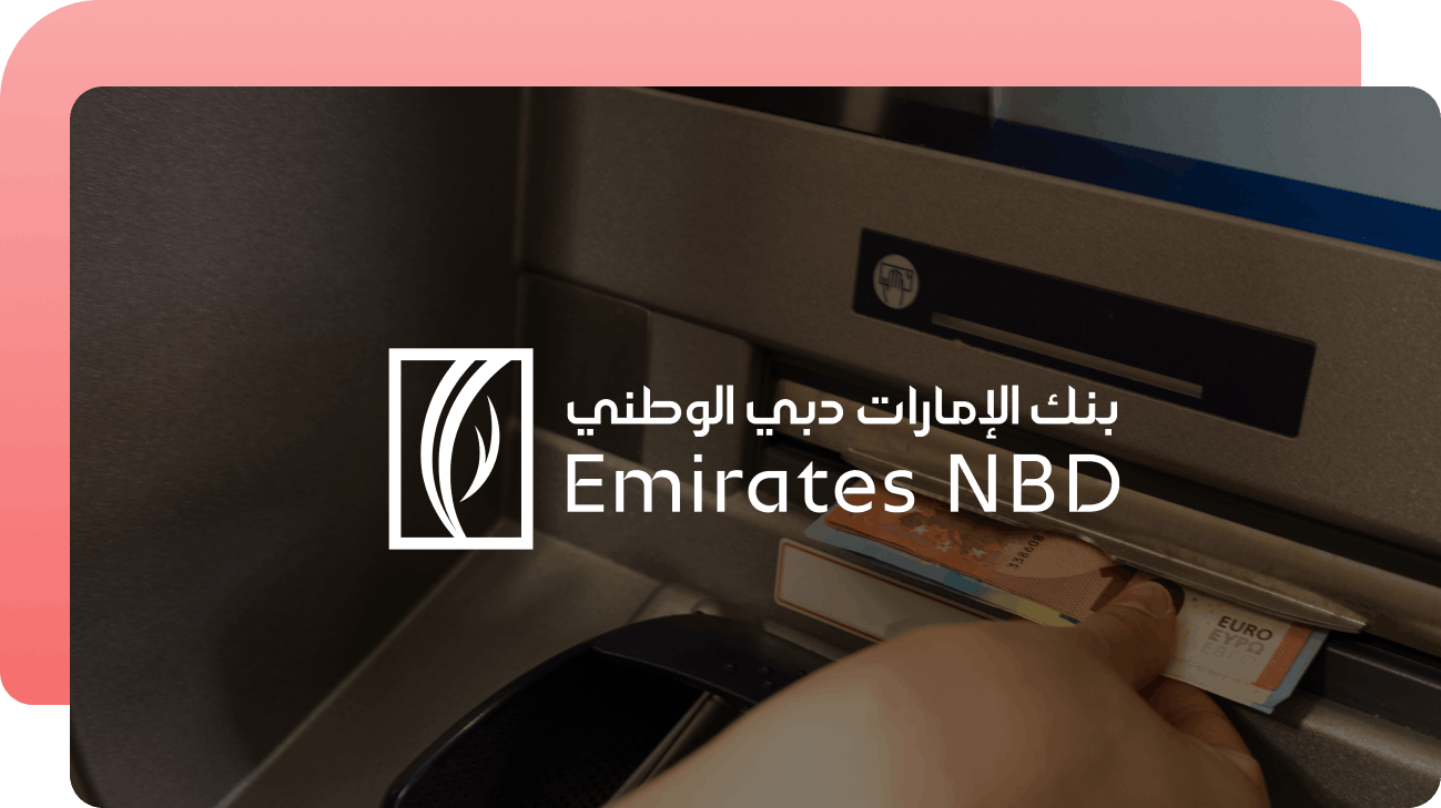 Emirates NBD logo over a hand inserting a bank card into a bank ATM
