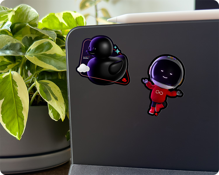 A tablet with Red Hat Developer-themed stickers on the back.