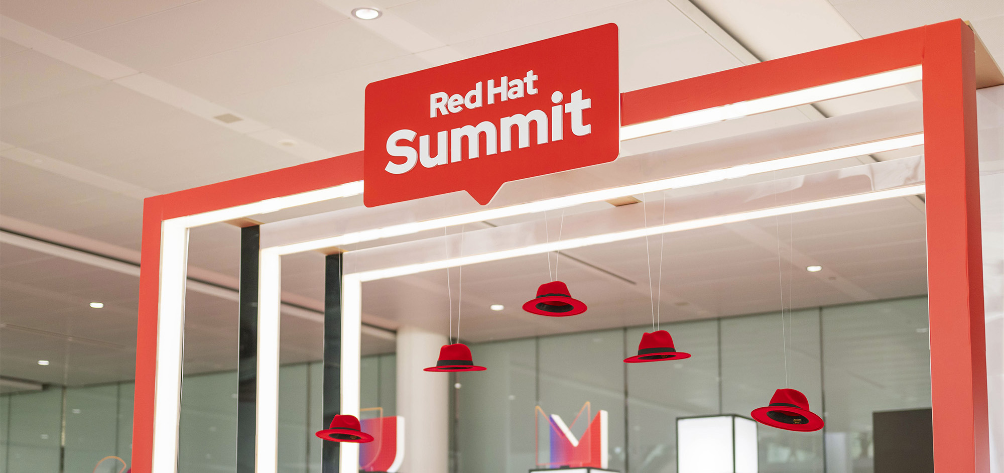 The Red Hat Summit logo sits at the top of a structure in a photospot at the event.