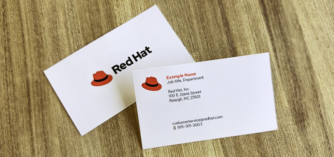 Photo of the front and back of Red Hat business cards.