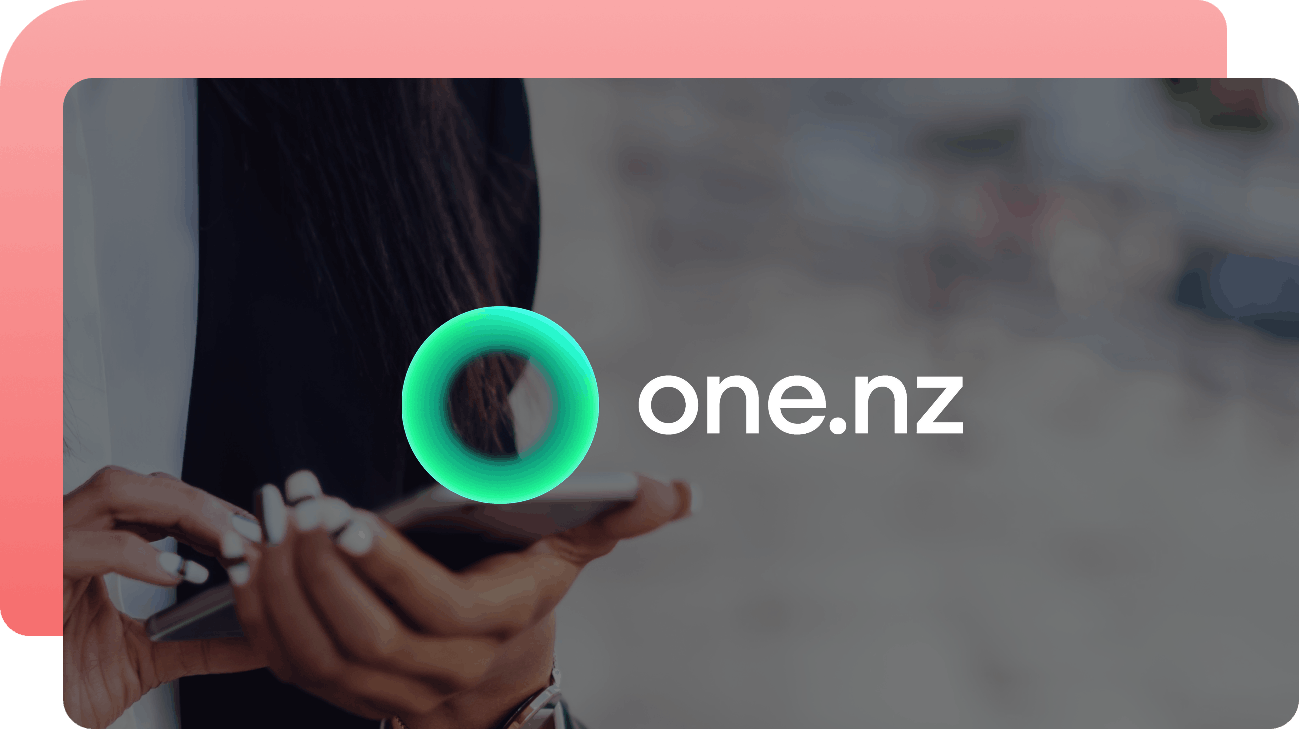 The One New Zealand logo over a photo of a person holding a smartphone