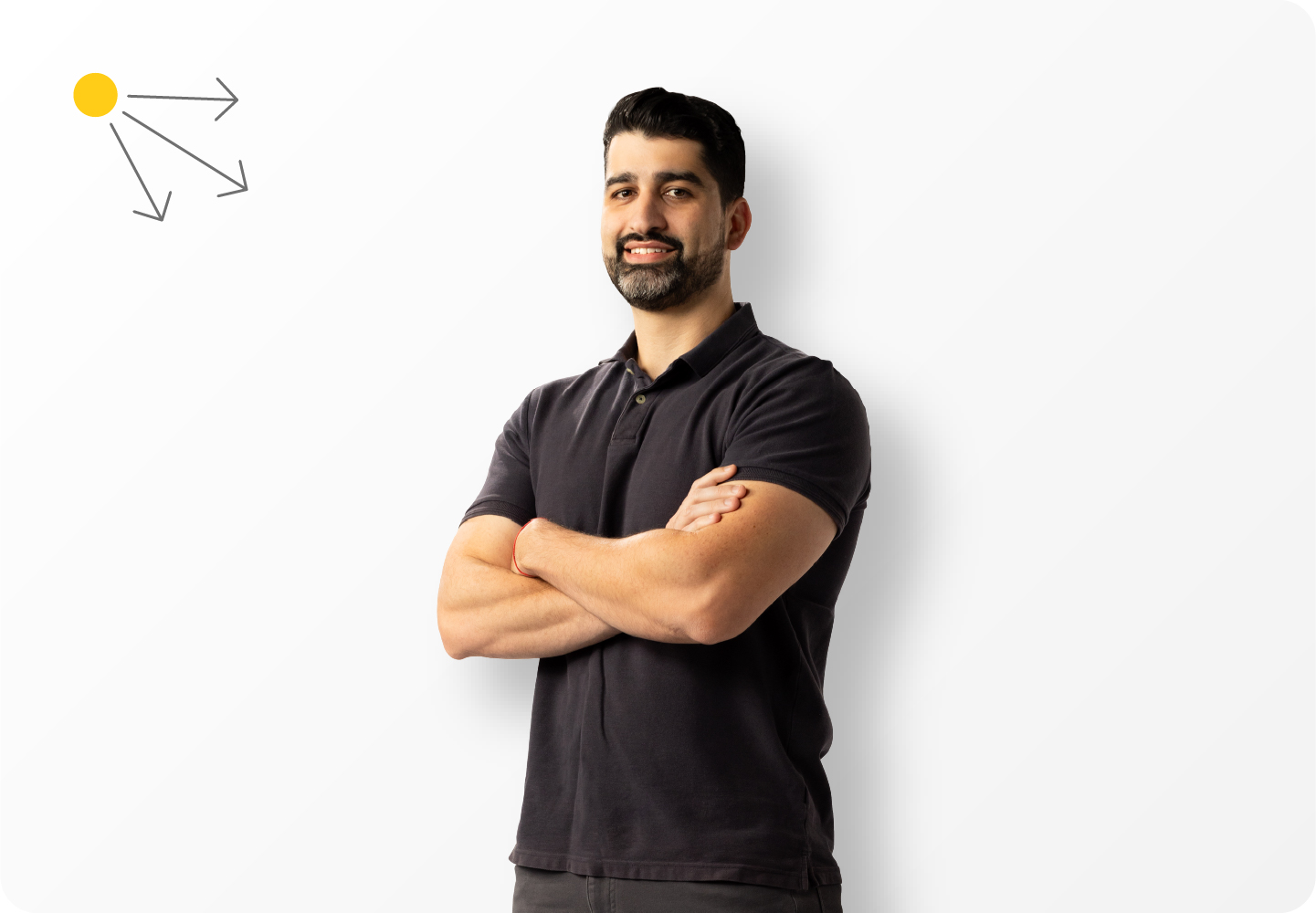 A studio portrait of a man wearing a black shirt. The light in the photo is coming from the upper left, so a subtle drop shadow that casts towards the lower right has been added to match the lighting in the photo and create distance from the background.