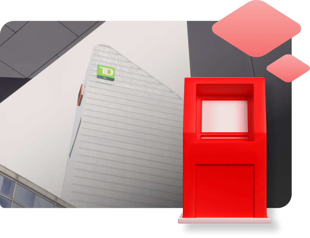 A bright red ATM kiosk stands before a modern skyscraper with TD logo on it