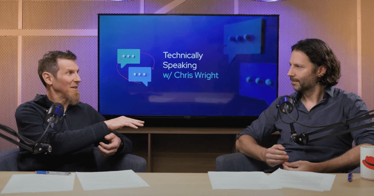 Chris Wright and Nick Hill with microphones at desk