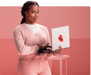 Woman holding laptop with Red Hat sticker
