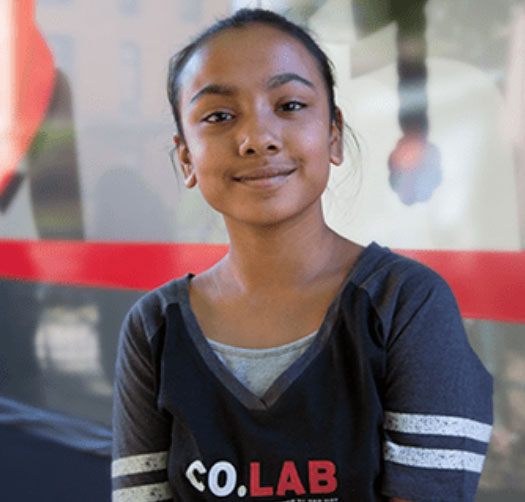 Girl in Co.Lab shirt