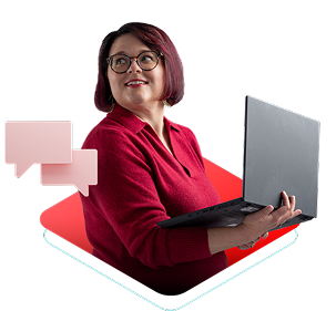 Woman with an open laptop smiling while chatting with Red Hat Consultant