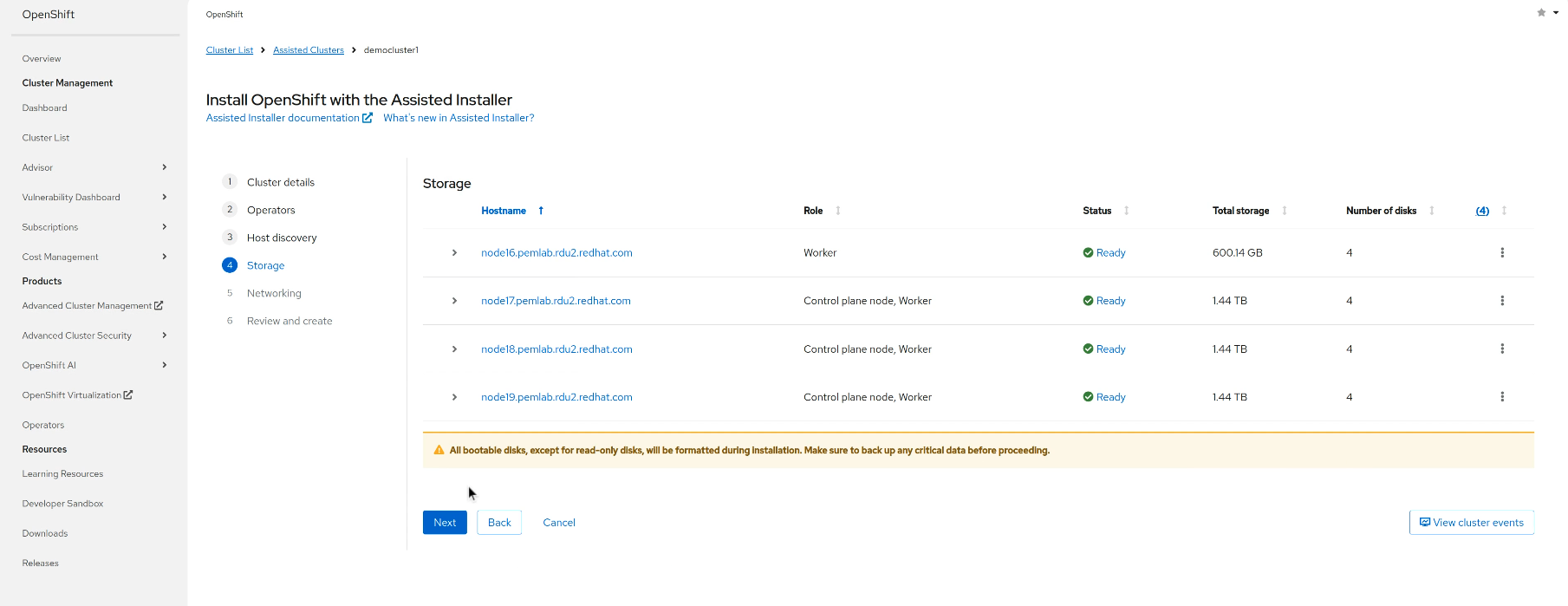 A screenshot of the OpenShift web console at the "Storage" step of the Assisted Installer. The page shows the Host Inventory, listing four hosts: one "Worker" node with 600.04 GB of total storage and three "Control plane node, Worker" nodes with 1.44 TB of storage each. All hosts are listed with a "Ready" status. A yellow warning banner at the bottom states, "All bootable disks, except for read-only disks, will be formatted during installation. Make sure to back up any critical data before proceeding."