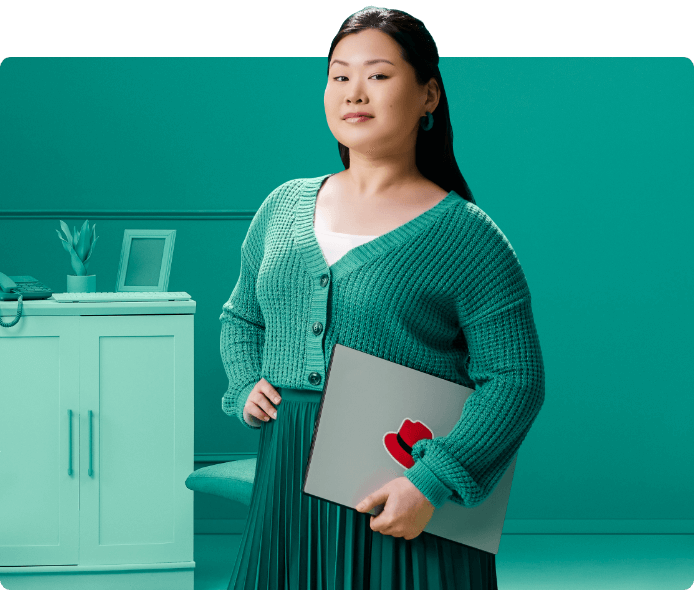 Woman holding laptop with Red Hat logo on it