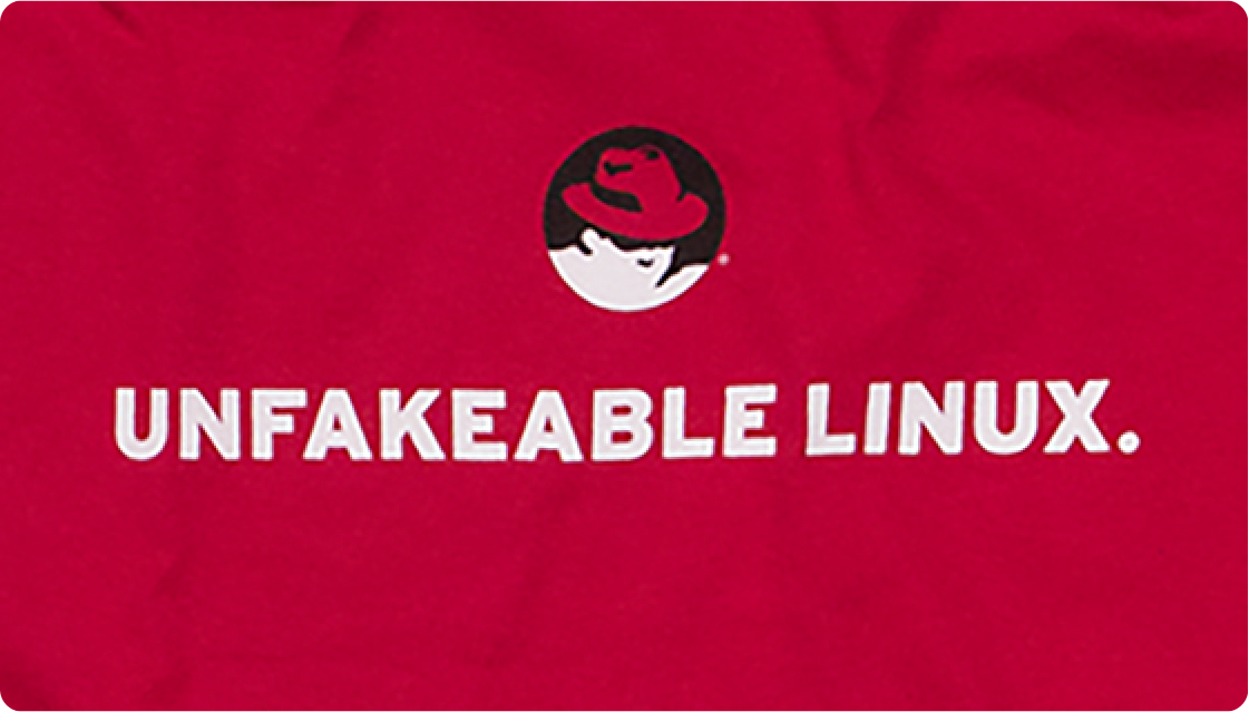 Red t-shirt with the Red Hat Shadowman logo and 'UNFAKEABLE LINUX' text.