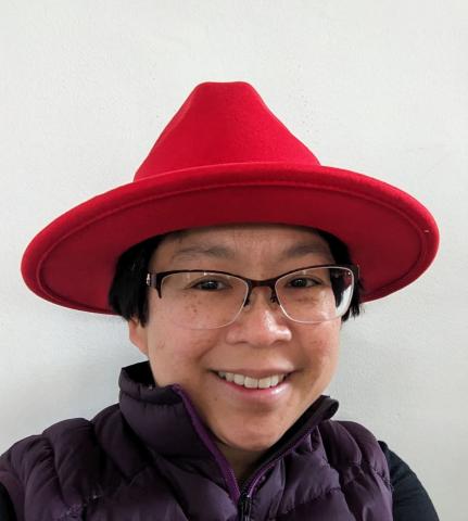Ju Lim wearing a Red fedora