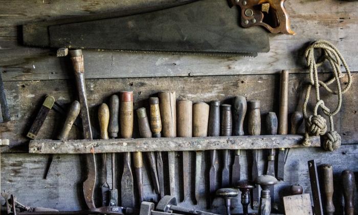A row of old tools for cutting and carving