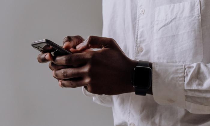 Man in white shirt using smartphone application