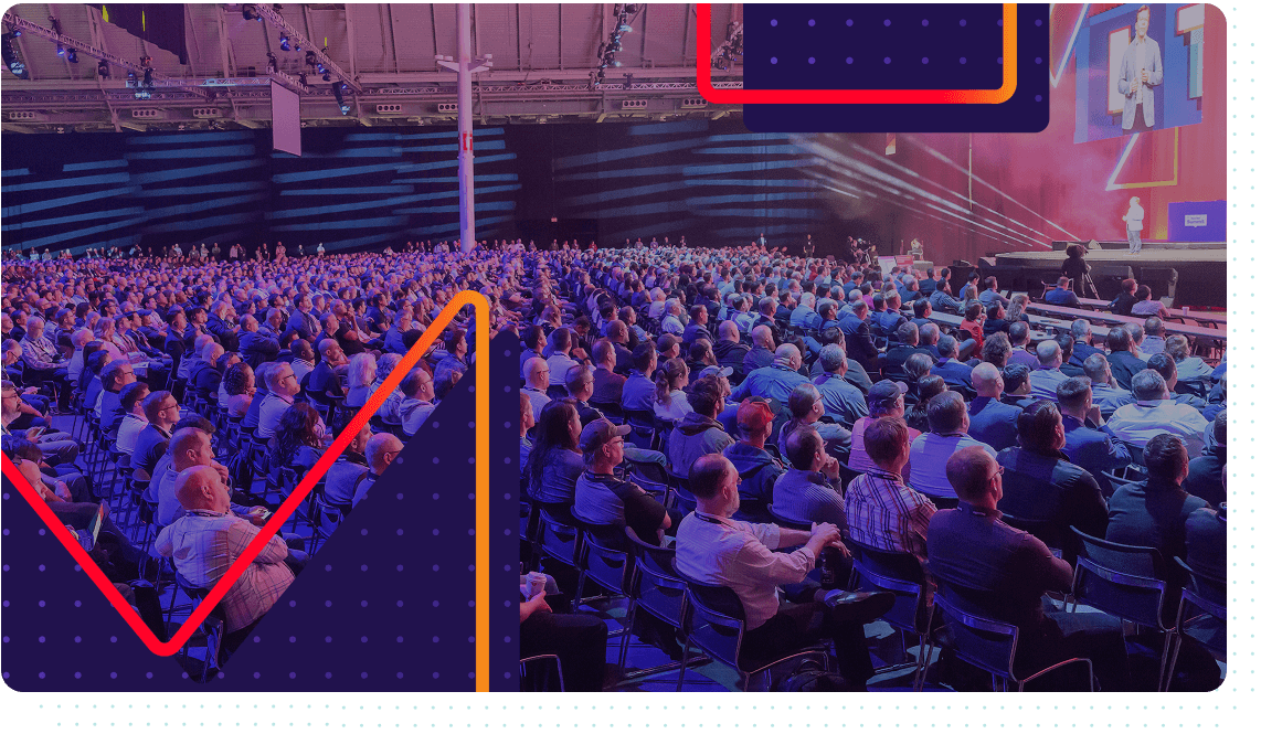 photograph taken from behind of audience watching a speaker at Red Hat Summit